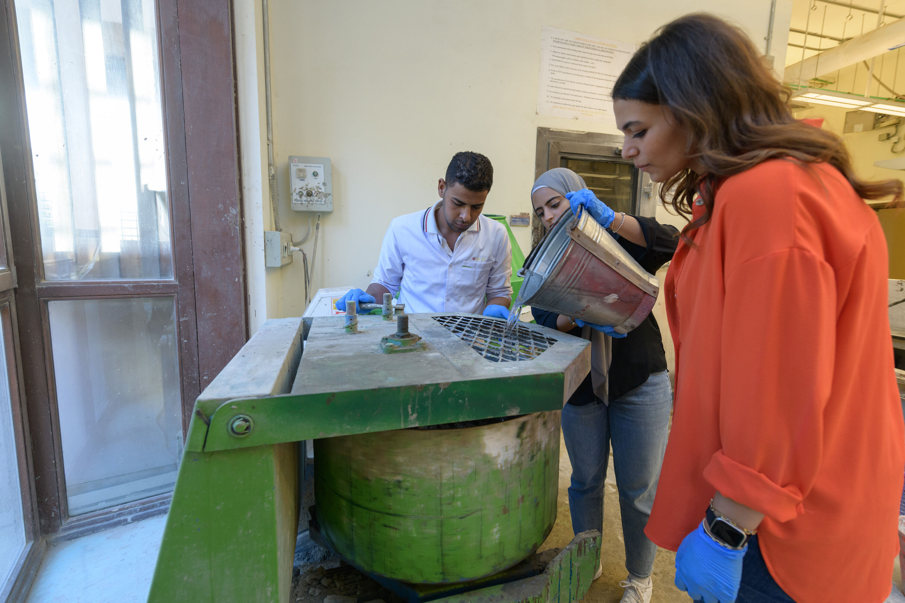 students working with cement and construction equipment in lab