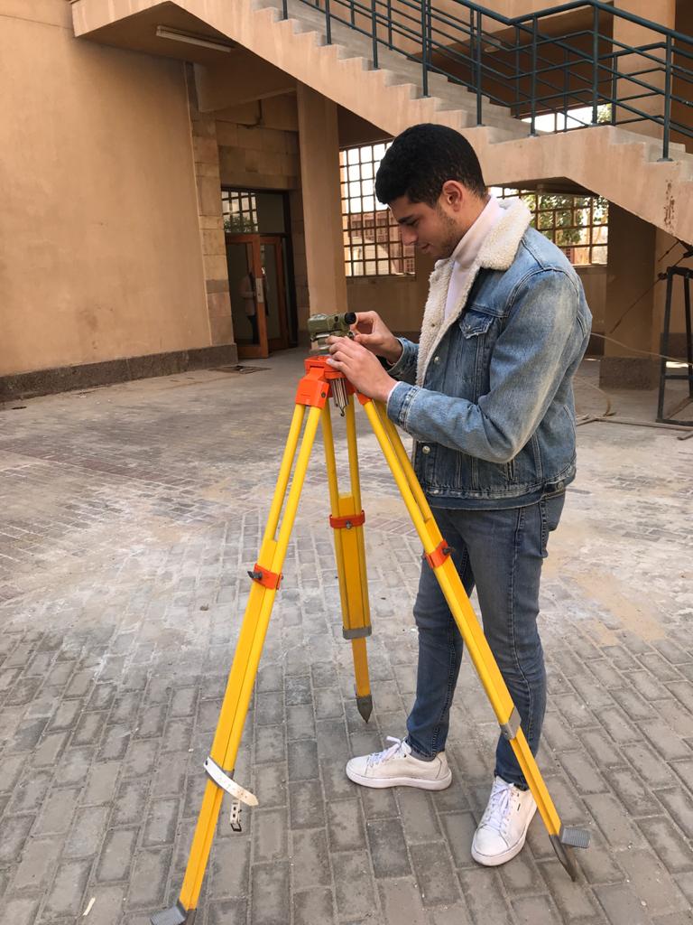 student with measuring equipment for architecture department