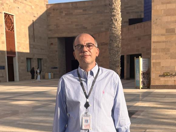 Man standing on campus wearing a shirt