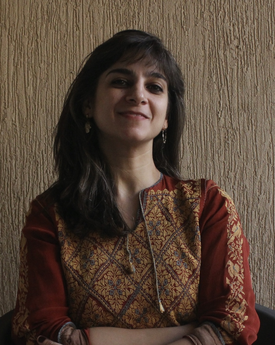 Headshot of a lady smiling with her hands crossed