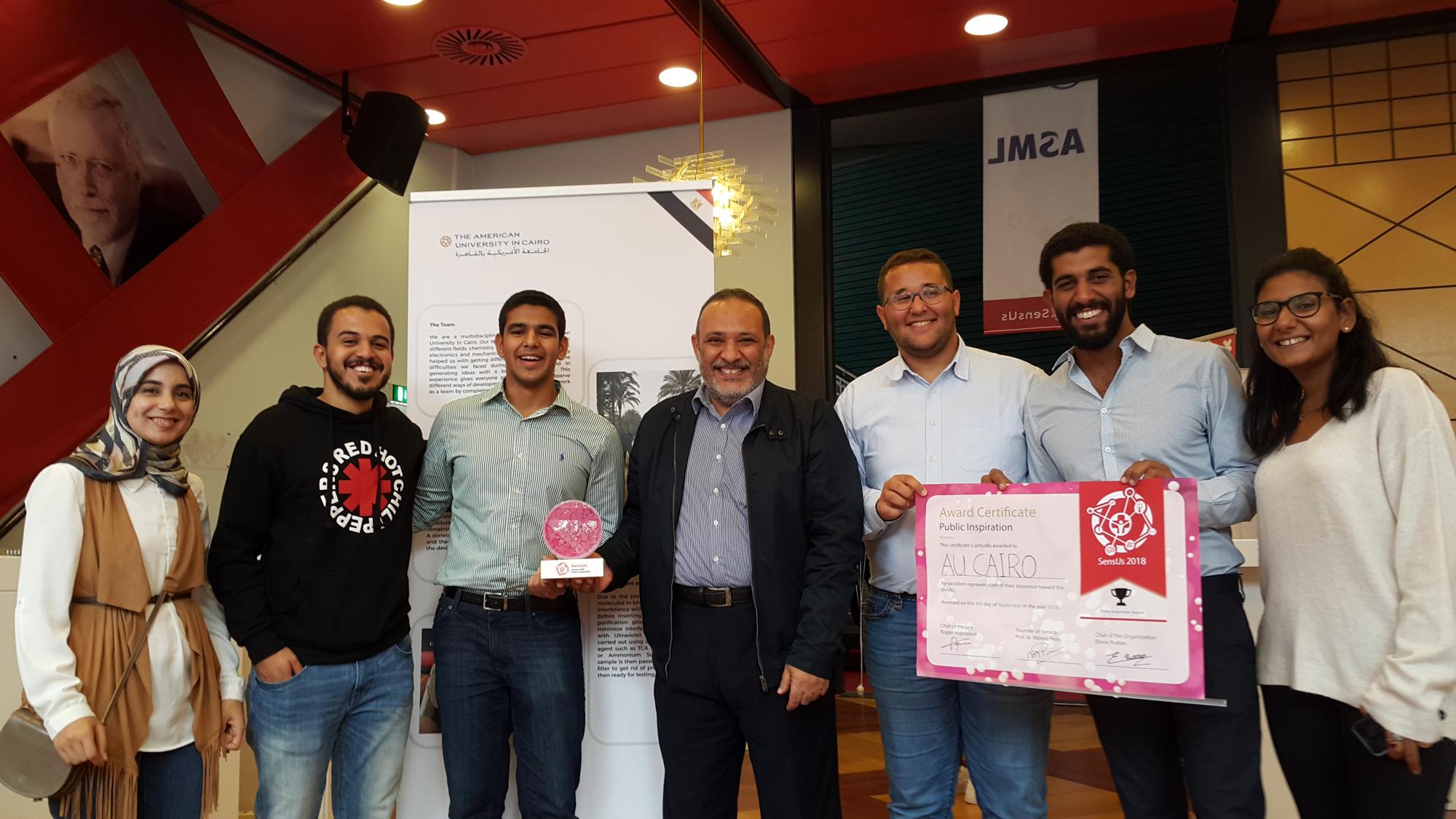 Azzazy (center) with the winning team of AUC students