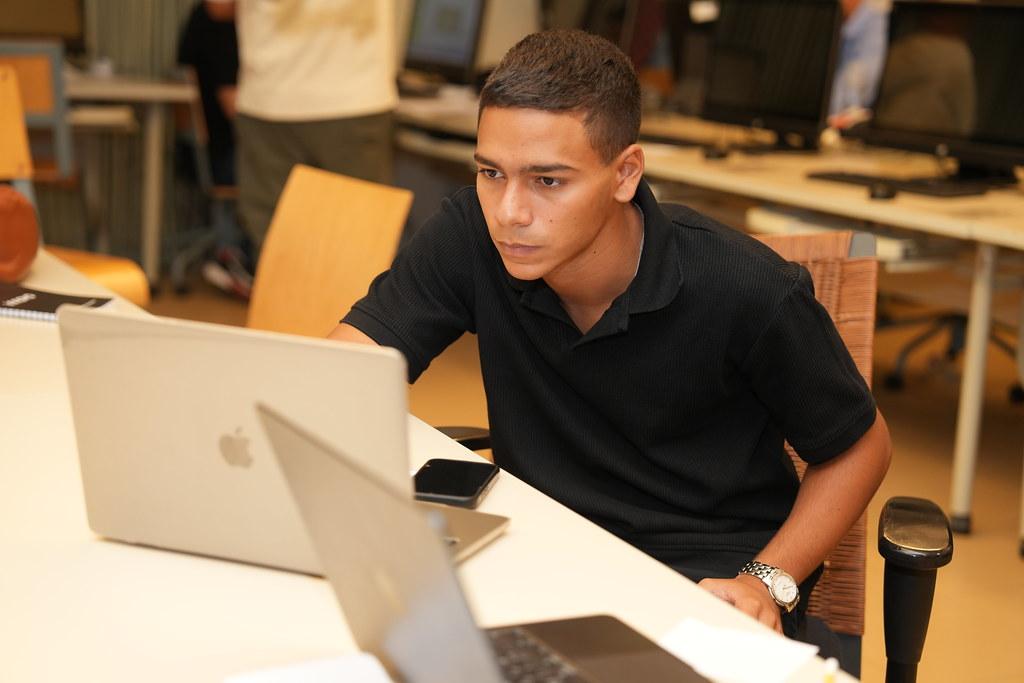 student working on laptop in computer lab