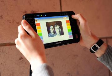 students holding a tablet