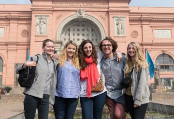group of students in front of a museum
