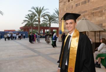 school of sciences graduate with cap and gown