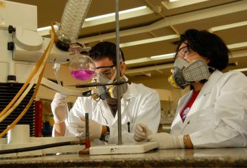 students in white coats in chemistry lab