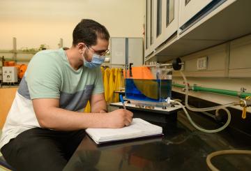 student working with equipment in mechanical engineering lab