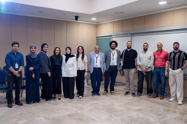 Group of people standing in a line inside a classroom