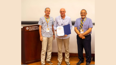 Hassan Azzazy (right) stands smiling with two other men who are part of the plasmonic sensing network.