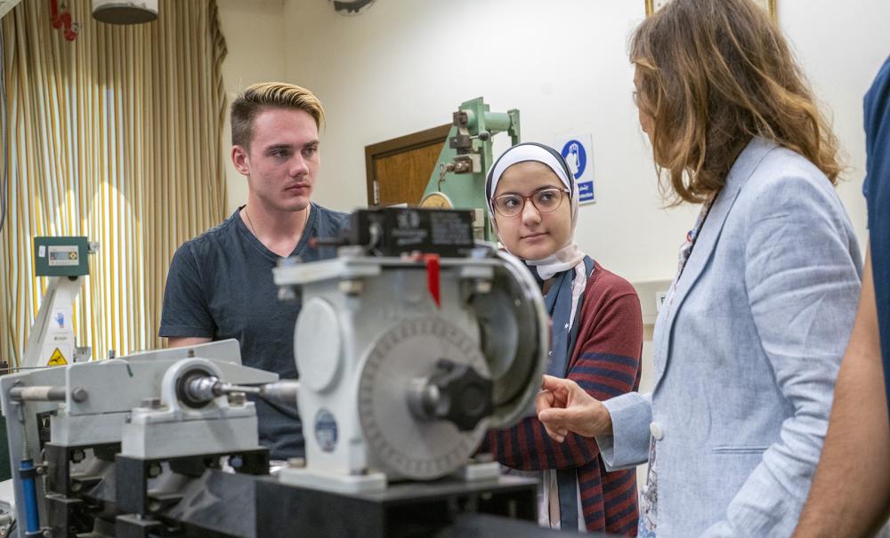 mechanical engineering equipment with students and faculty working with the machines