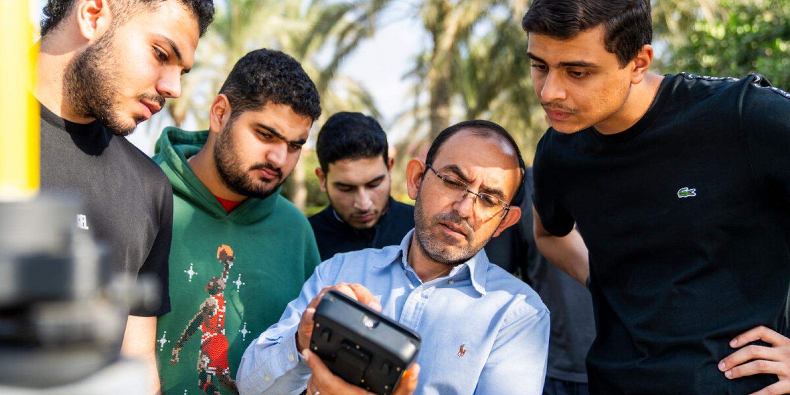 group of students working together on a engineering measuring equipment