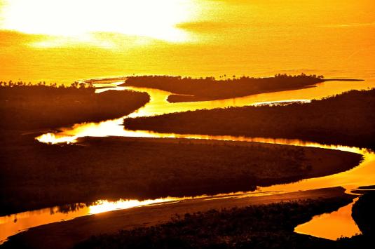 Sun shining over a river