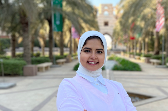 Shimaa Heikal (MSc '22), PhD candidate posing in the AUC garden
