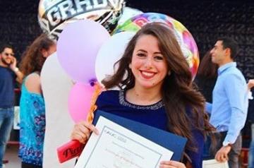 A girl posing for her graduation photo