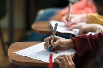 students writing in class