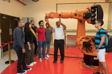 Professor explaining a machine to students