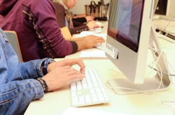 Close-up on student typing on mac