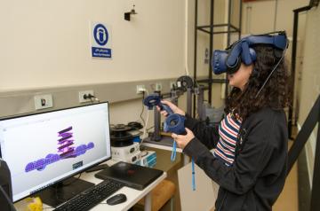 Female student trying the VR equipment in the lab