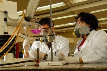 students in white coats in chemistry lab