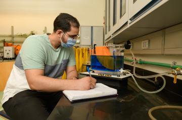 student working with equipment in mechanical engineering lab