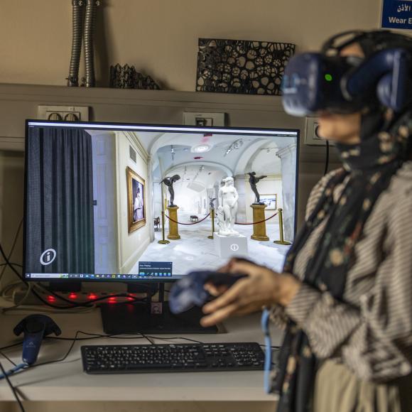 student using VR equipment to walk through a museum 
