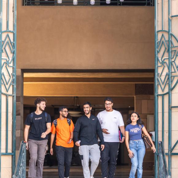 group of students leaving sciences and engineering building going outside 