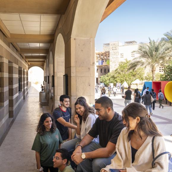 students socializing on campus during assembly hour